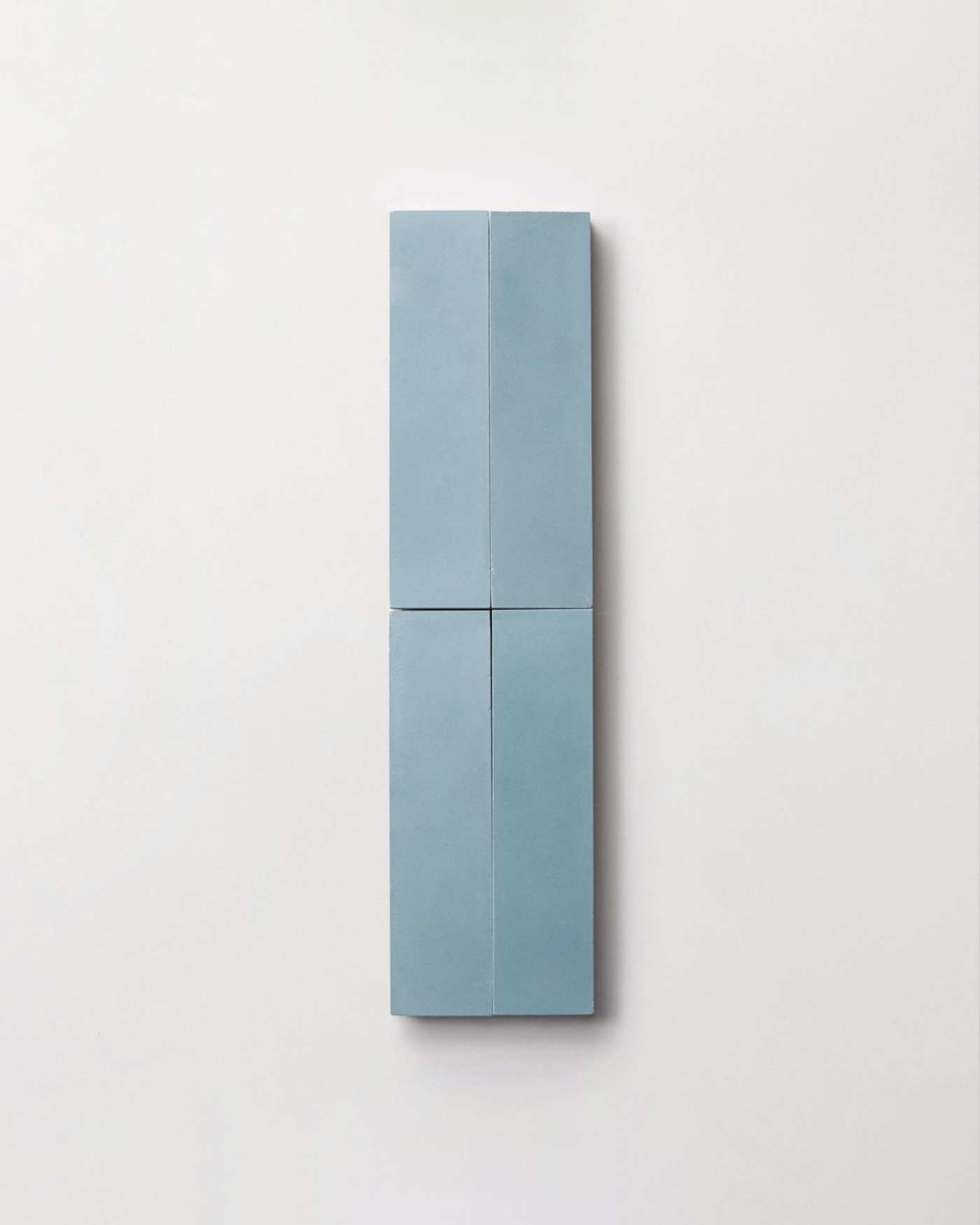 four blue rectangle tiles on a white surface.