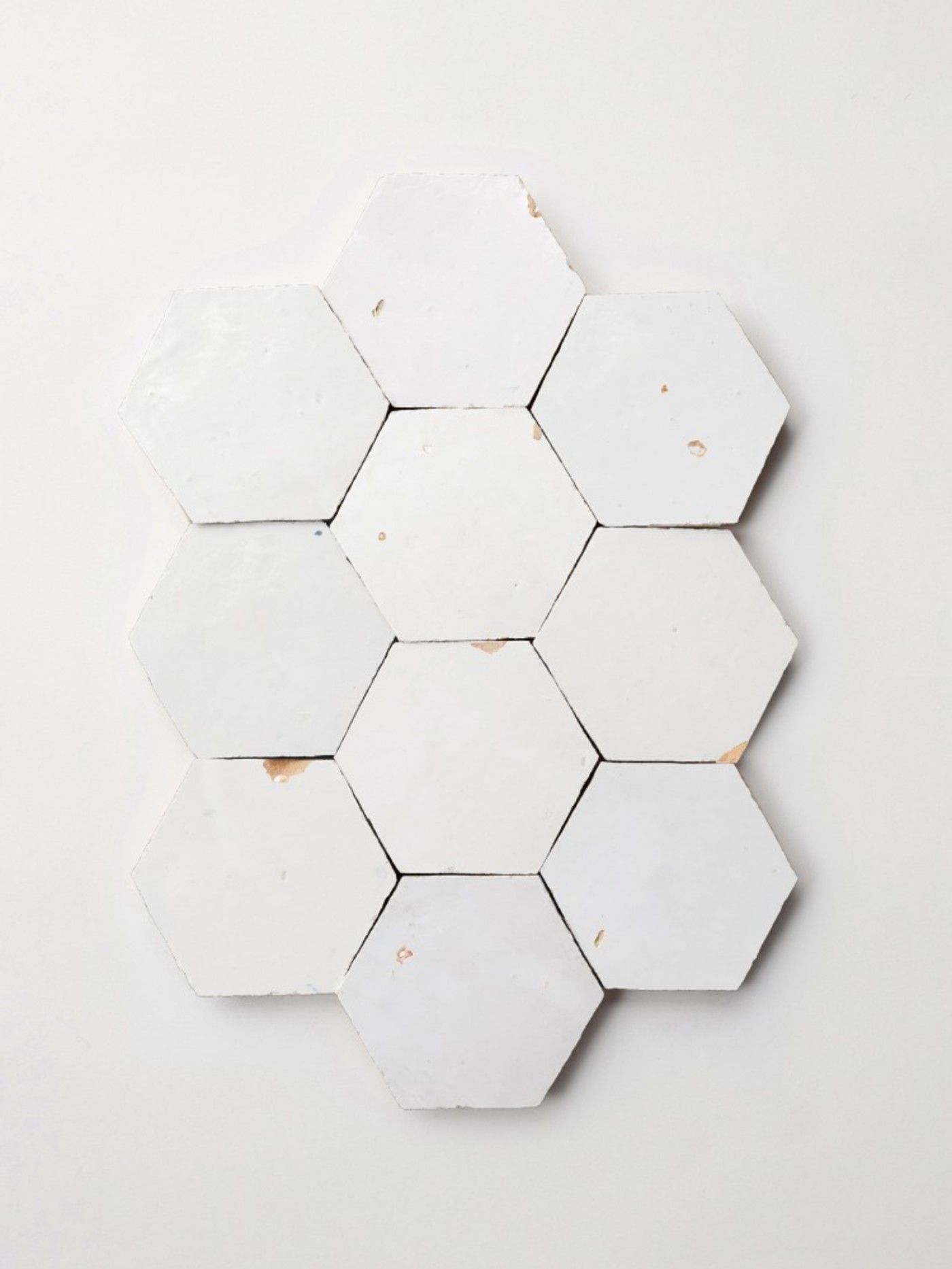 white hexagonal tiles on a white surface.