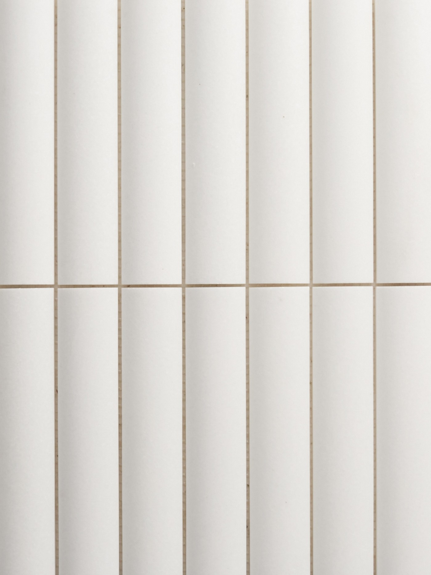 a close up image of a white tiled wall.