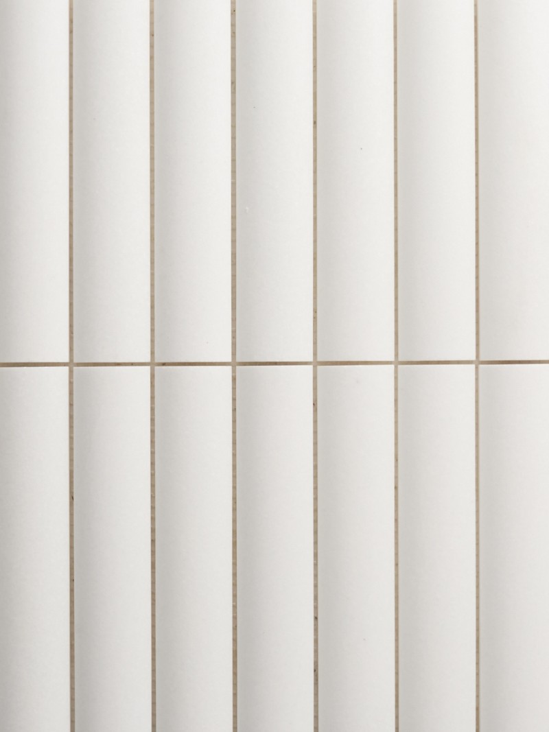 a close up image of a white tiled wall.