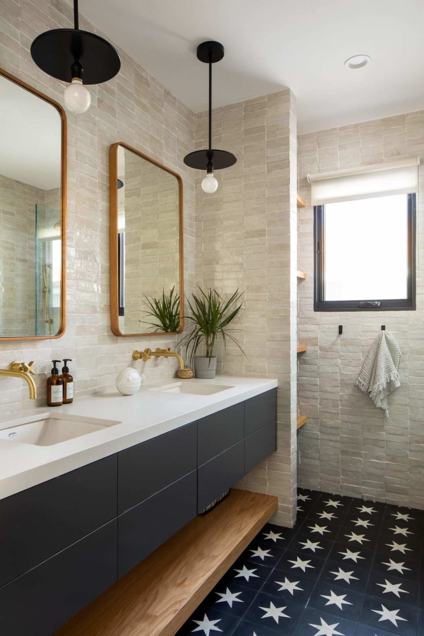 a bathroom with a black and white tiled floor.