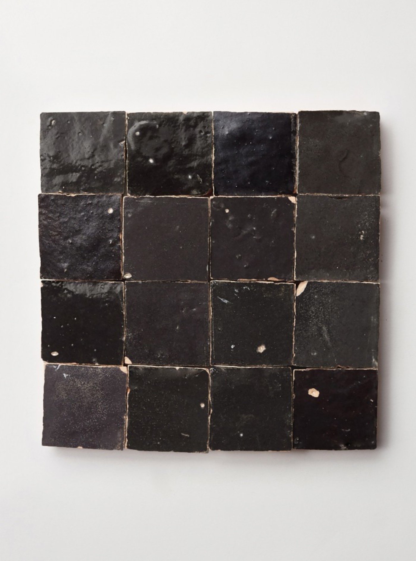 square black tiles on a white surface.