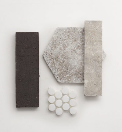 a group of tiles, bricks, and soaps on a white surface.