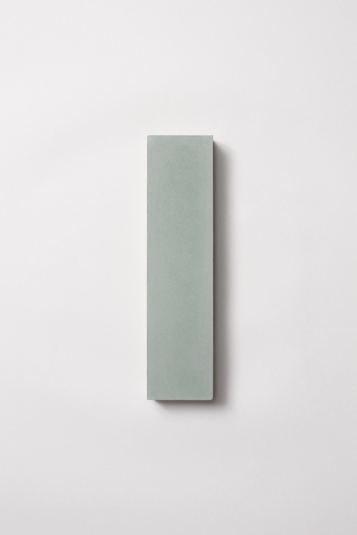 a green rectangle tile on a white surface.