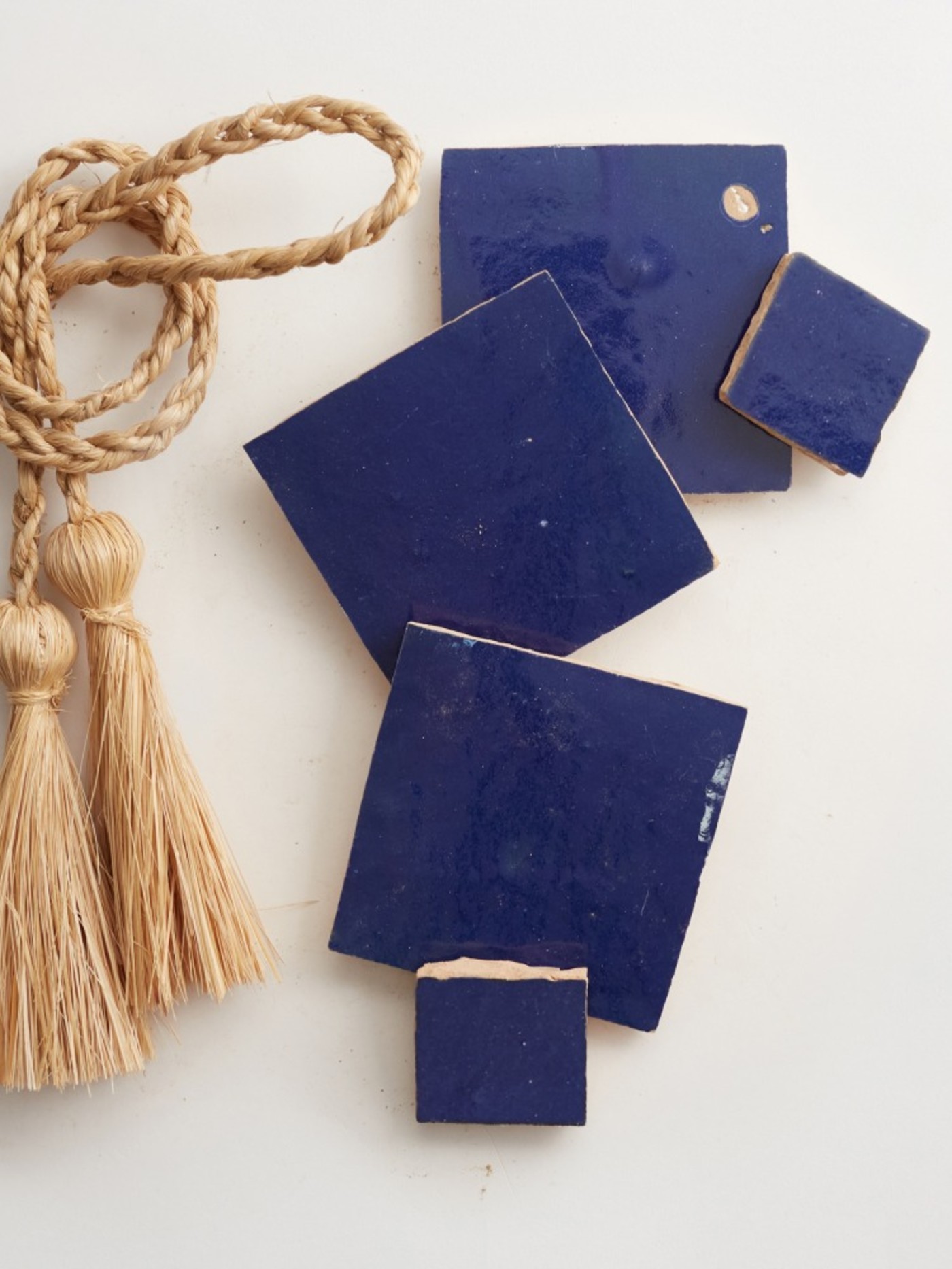 blue ceramic tiles and tassels on a white surface.