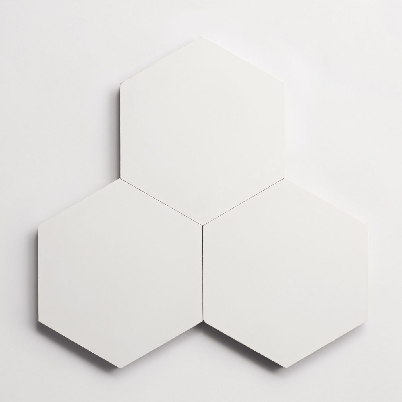 three white hexagons on a white surface.