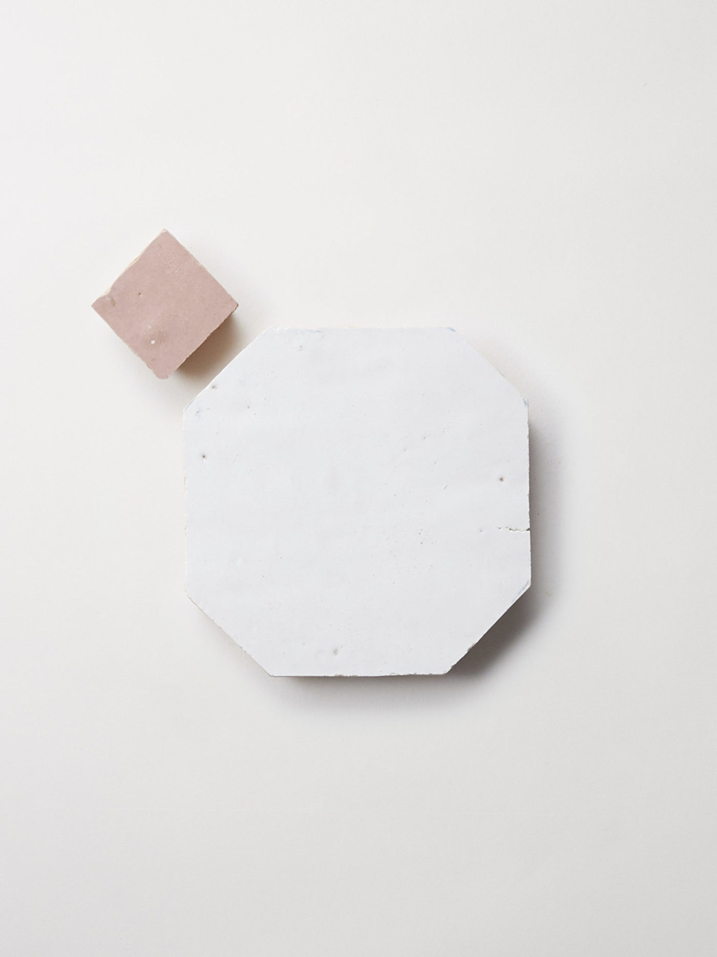 a white and pink marble plate on a white surface.