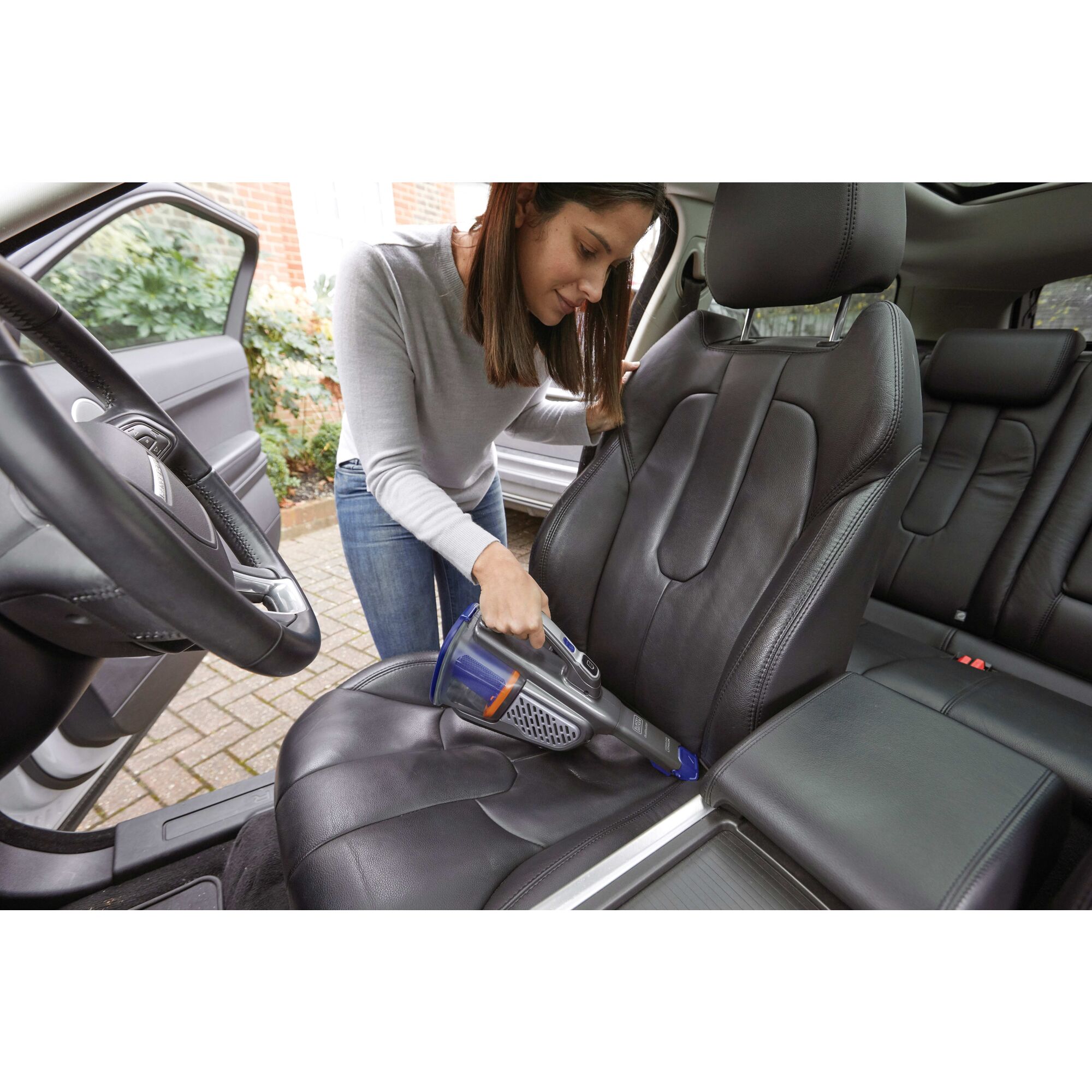 20 Volt MAX dust buster Advanced Clean + Pet Hand Vacuum being used to clean hard to reach areas of car.