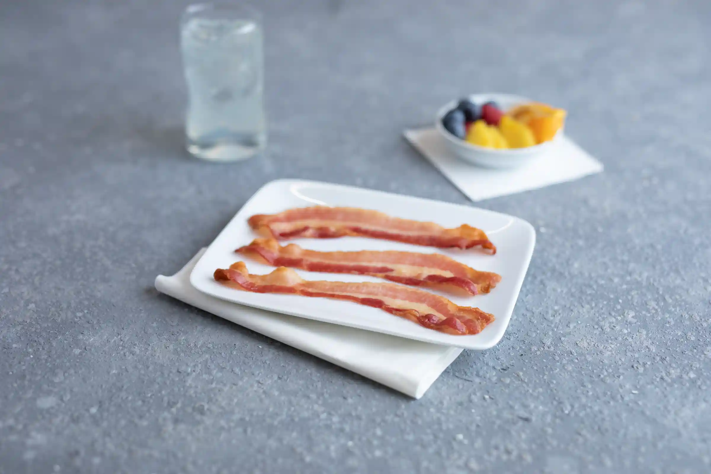 Wright® Brand Naturally Hickory Smoked Regular Sliced Flat-Pack® Bacon, 15 lbs, 14-18 Slices per Pound, Gas Flushed https://images.salsify.com/image/upload/s--Q7FyJfww--/q_25/wpr9nl1sx1gpzrtimaz3.webp