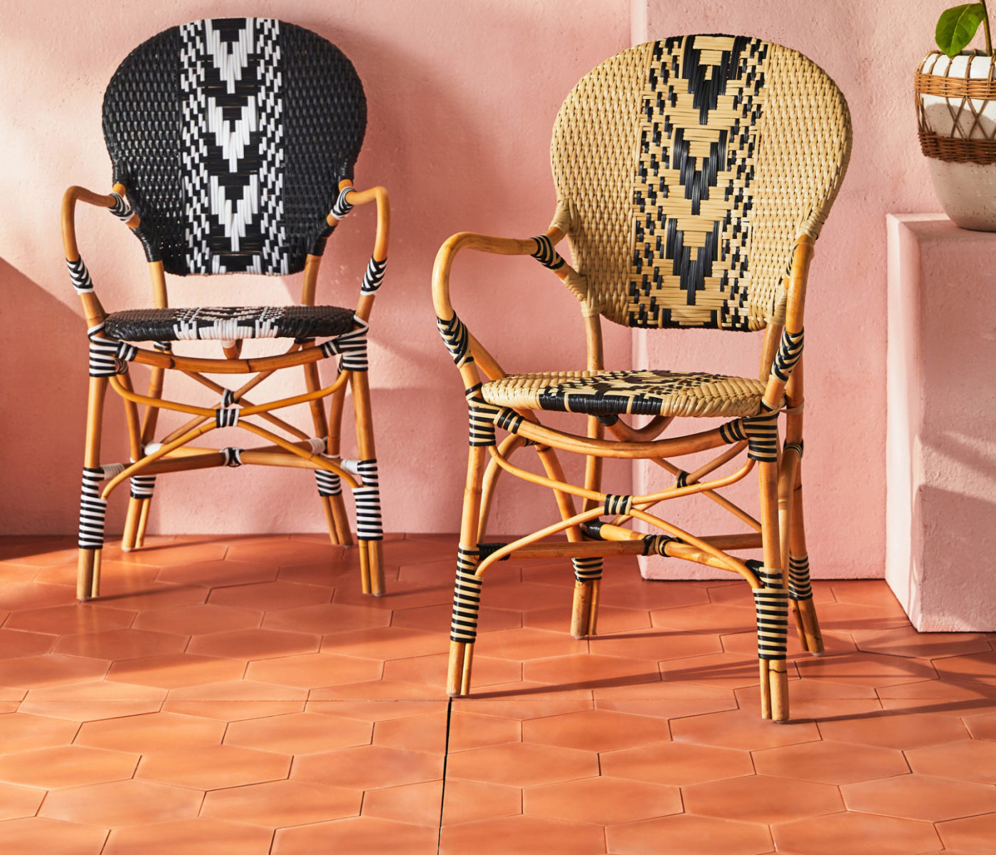 two wicker chairs on an orange tiled floor.