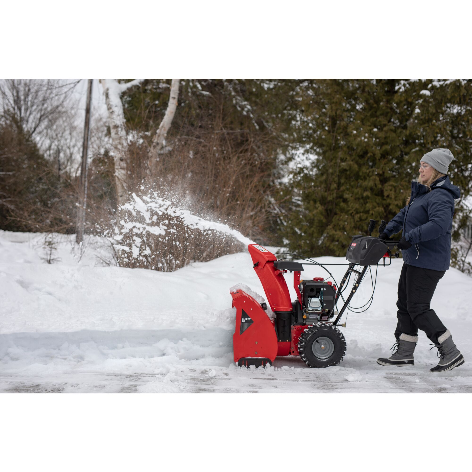 SELECT 26 inch 243 CC two stage gas snow blower with push button electric start being used.