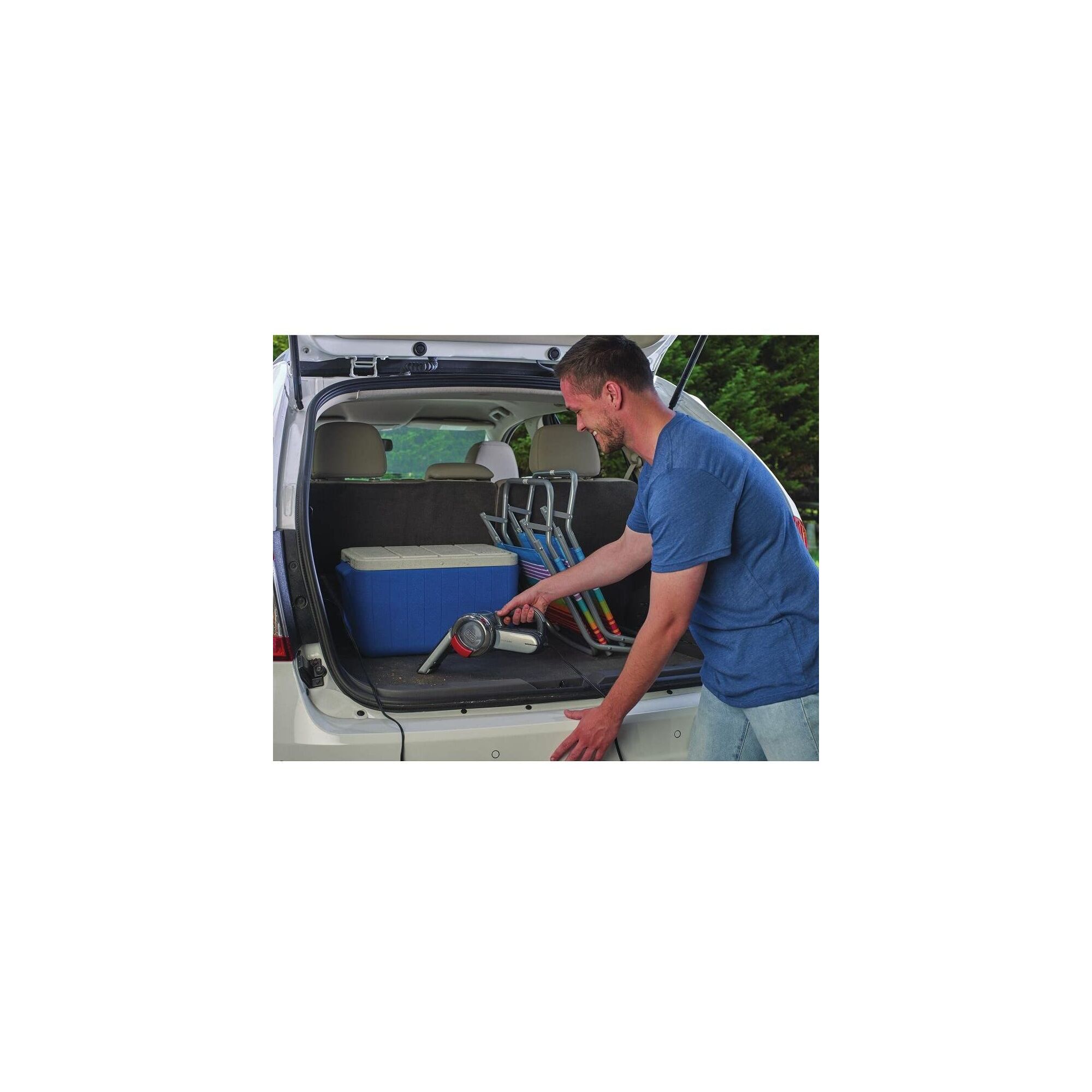 Man using Auto Vacuum to clean the back of a small SUV.