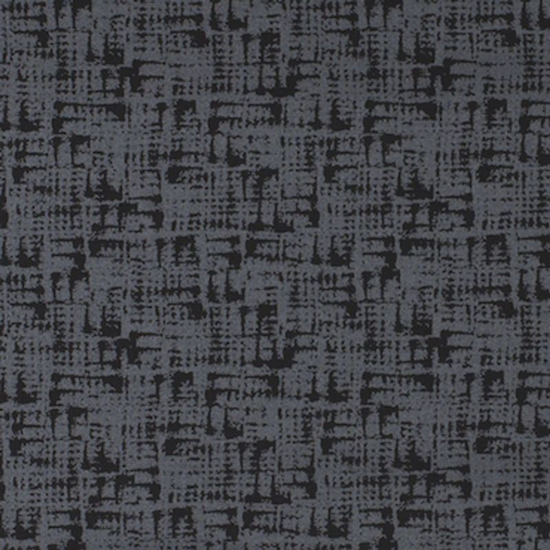 Patterned dark-gray carpet with irregular black crosshatch texture â€” covering a flat floor surface â€” in a dimly lit indoor setting, appearing uniform and tightly woven.
