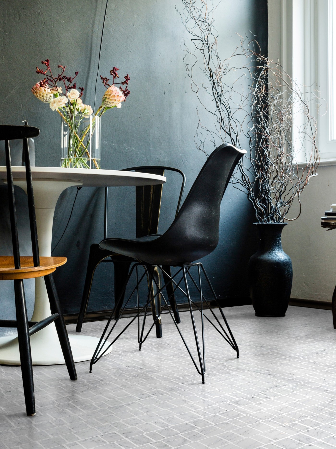 a dining room with a table and chairs and tiled floor.