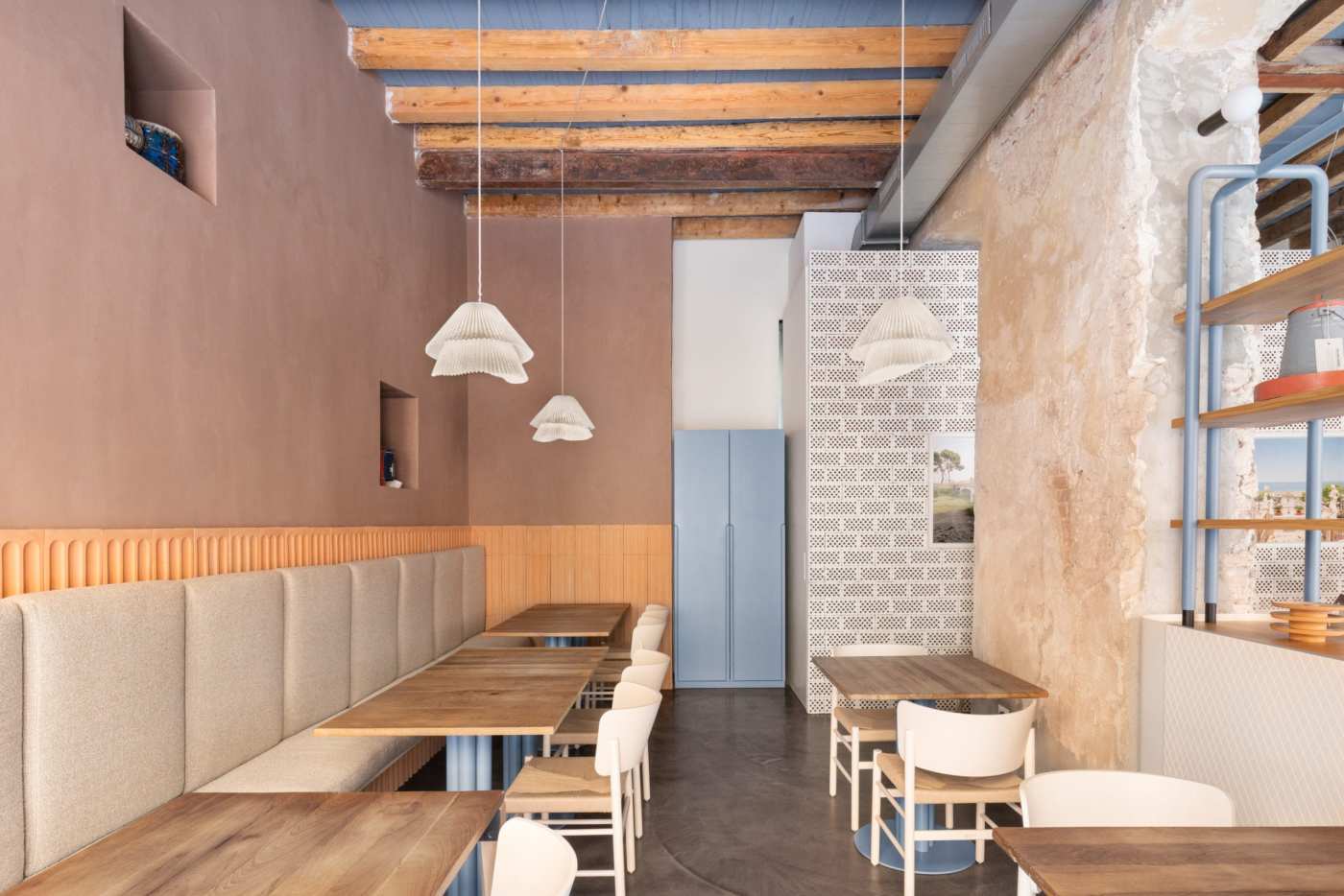 the interior of a restaurant with wooden tables and chairs.