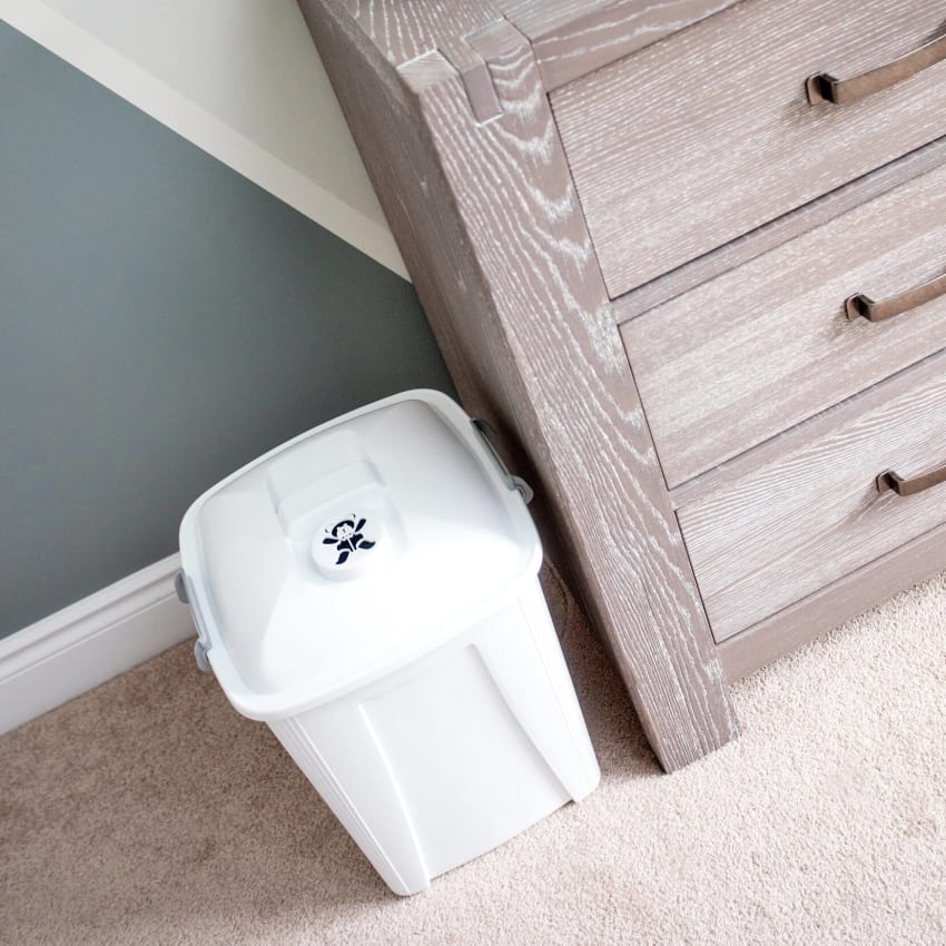 plastic diaper collection container for baby diapers in a nursery room