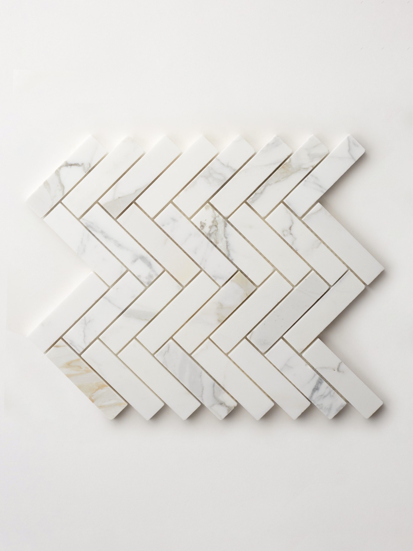 a white marble herringbone tile sheet on a white background.