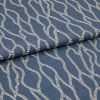 Blue woven fabric with cream embroidered wavy rope pattern, folded over itself, shown in a close-up studio view with soft, even lighting.
