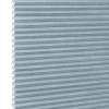 Light-blue cellular (honeycomb) shade, pleated horizontal cells with white interior along left edge; fully lowered and closed, blocking light; shown as product against a plain white background.