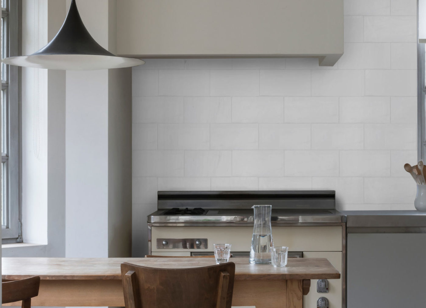 a white kitchen with a wooden table and chairs.