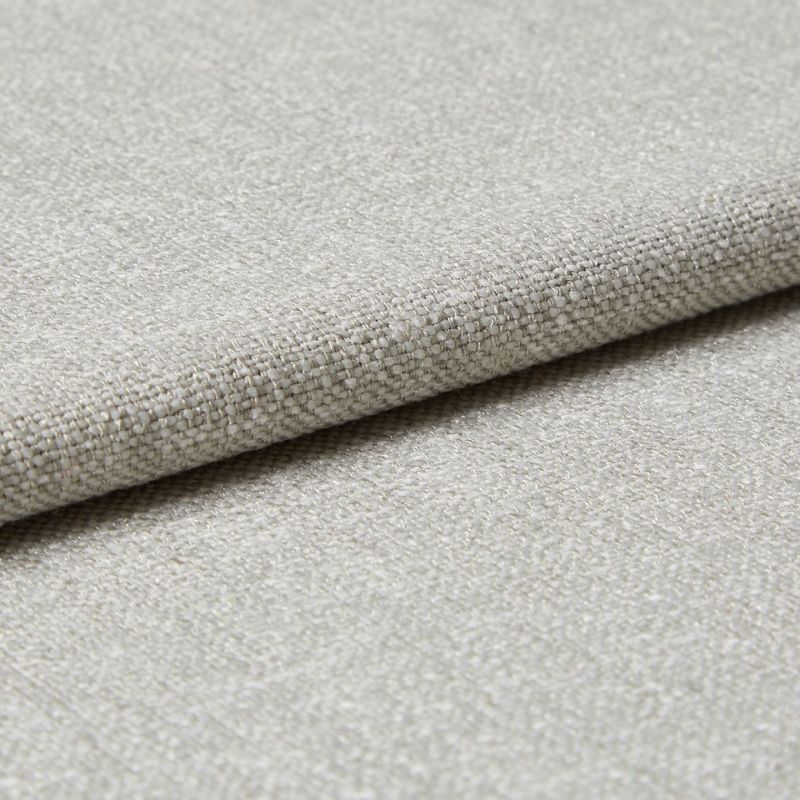 Beige woven fabric swatch, folded and layered, showing coarse basket-weave texture and subtle sheen; photographed in close-up with neutral lighting on a flat surface.