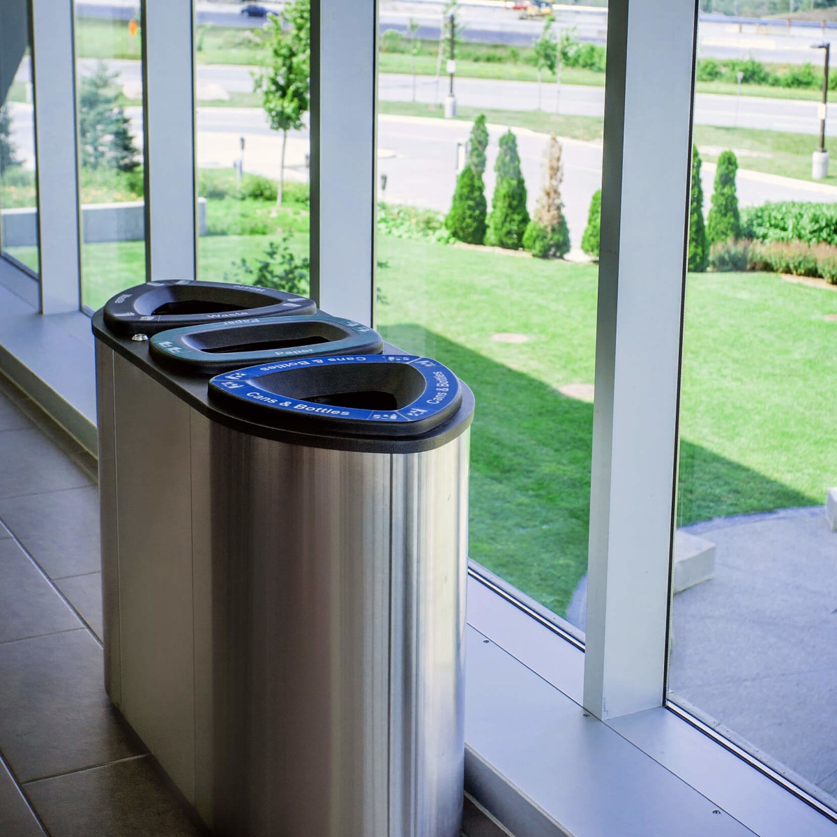 triple recycling organics and trash container with a stainless steel body at a university campus