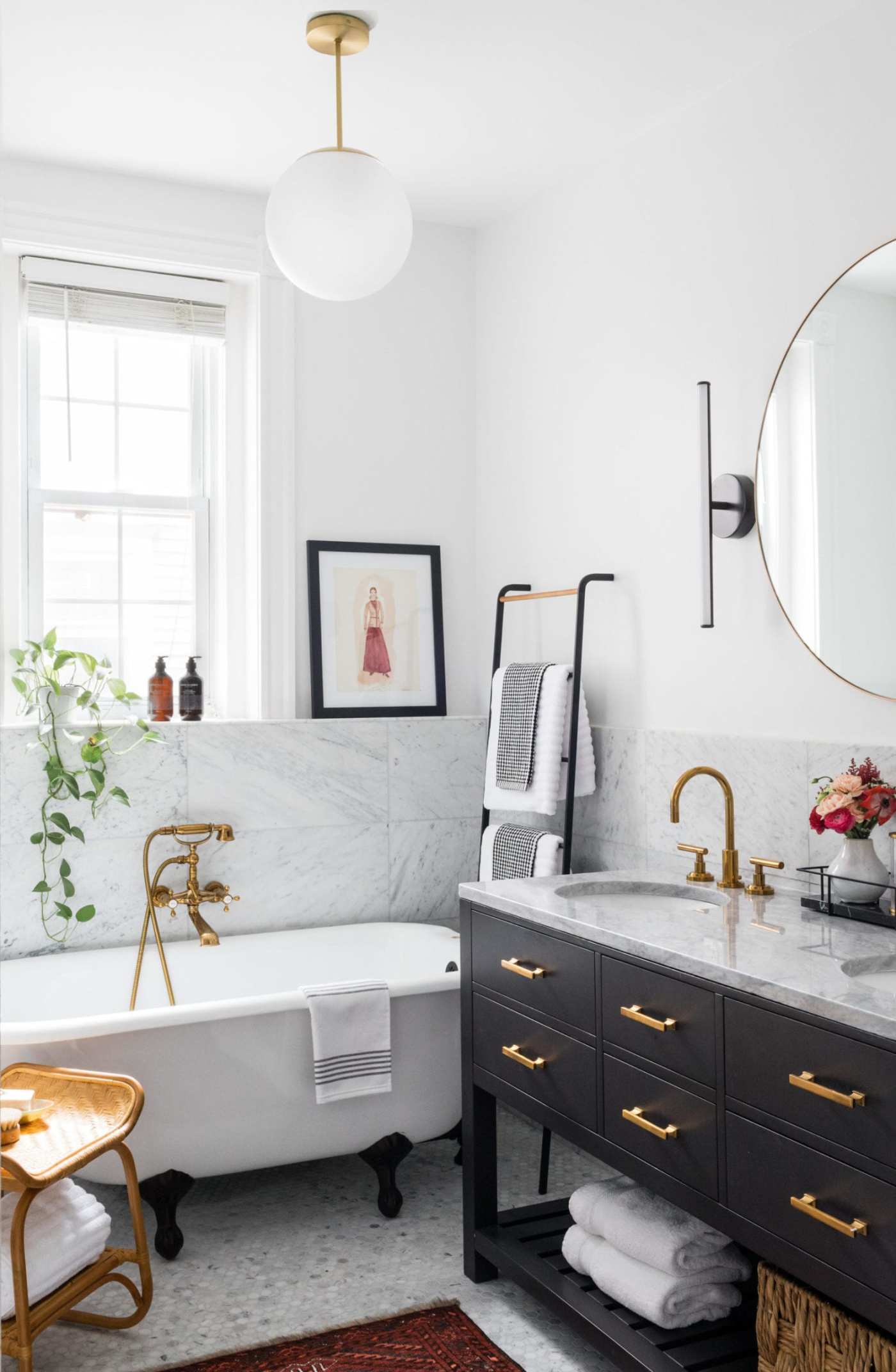 a black and white bathroom with gold accents.