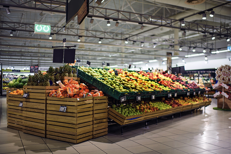 Bins of brightly colored fruit at a supermarket