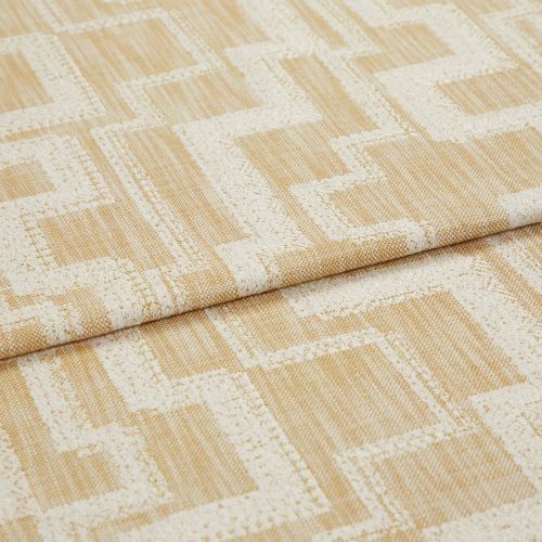 Curtain fabric folded and layered, woven beige cloth with raised cream geometric square/maze pattern; close-up textile shot on flat surface with soft, neutral lighting.