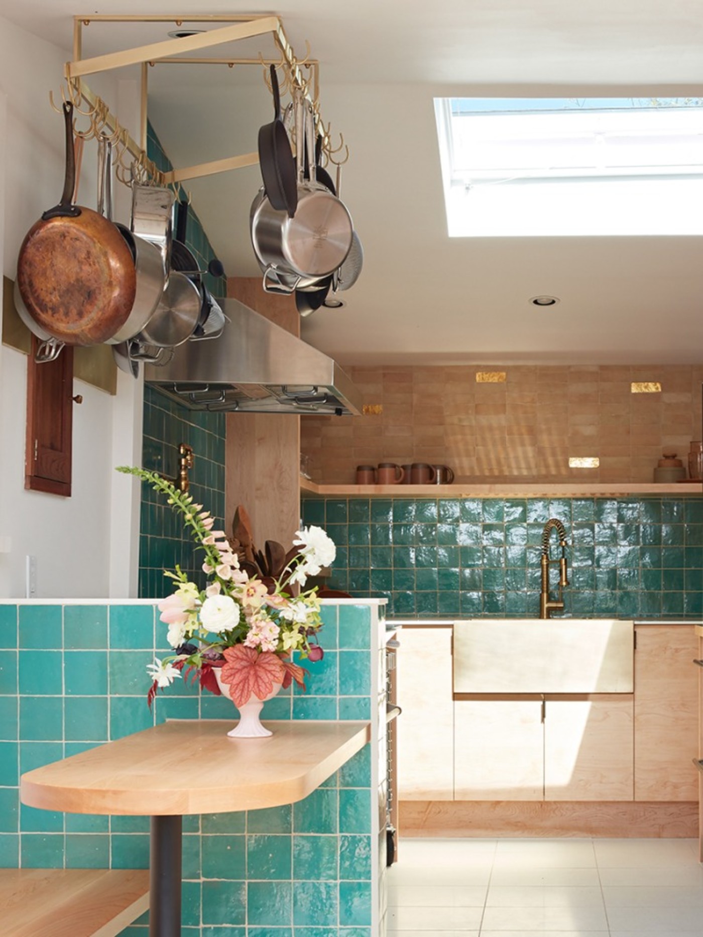 a kitchen with a table and pots and pans.