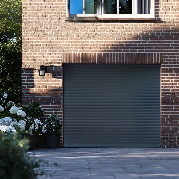 Horizontal slatted metal roller shutter covering garage opening, closed and blocking view; set in red brick wall beneath a window, with exterior lamp, potted white flowers and soft afternoon light.