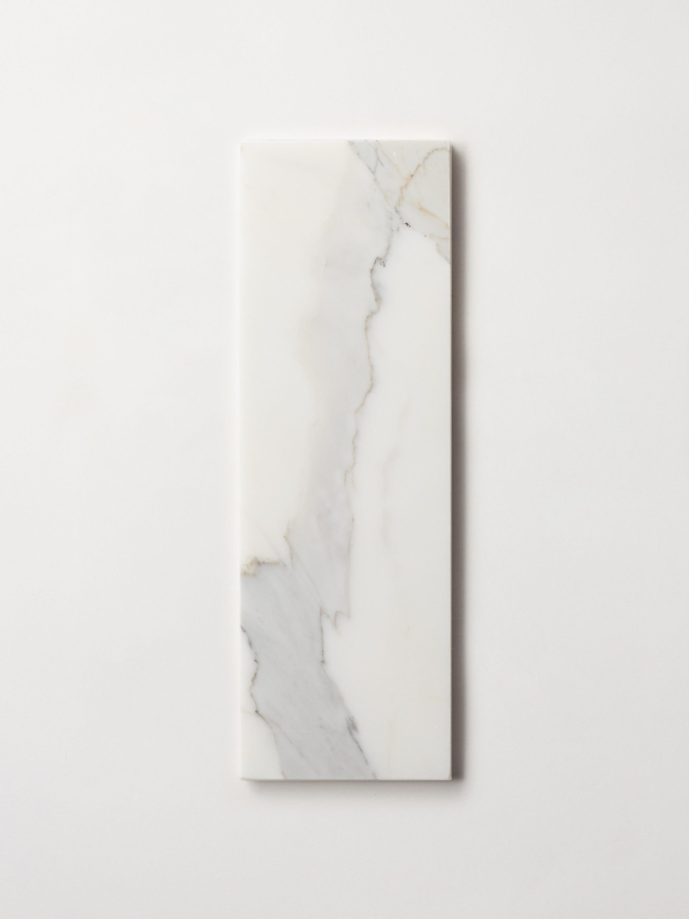 a white rectangle marble tile on a white surface.