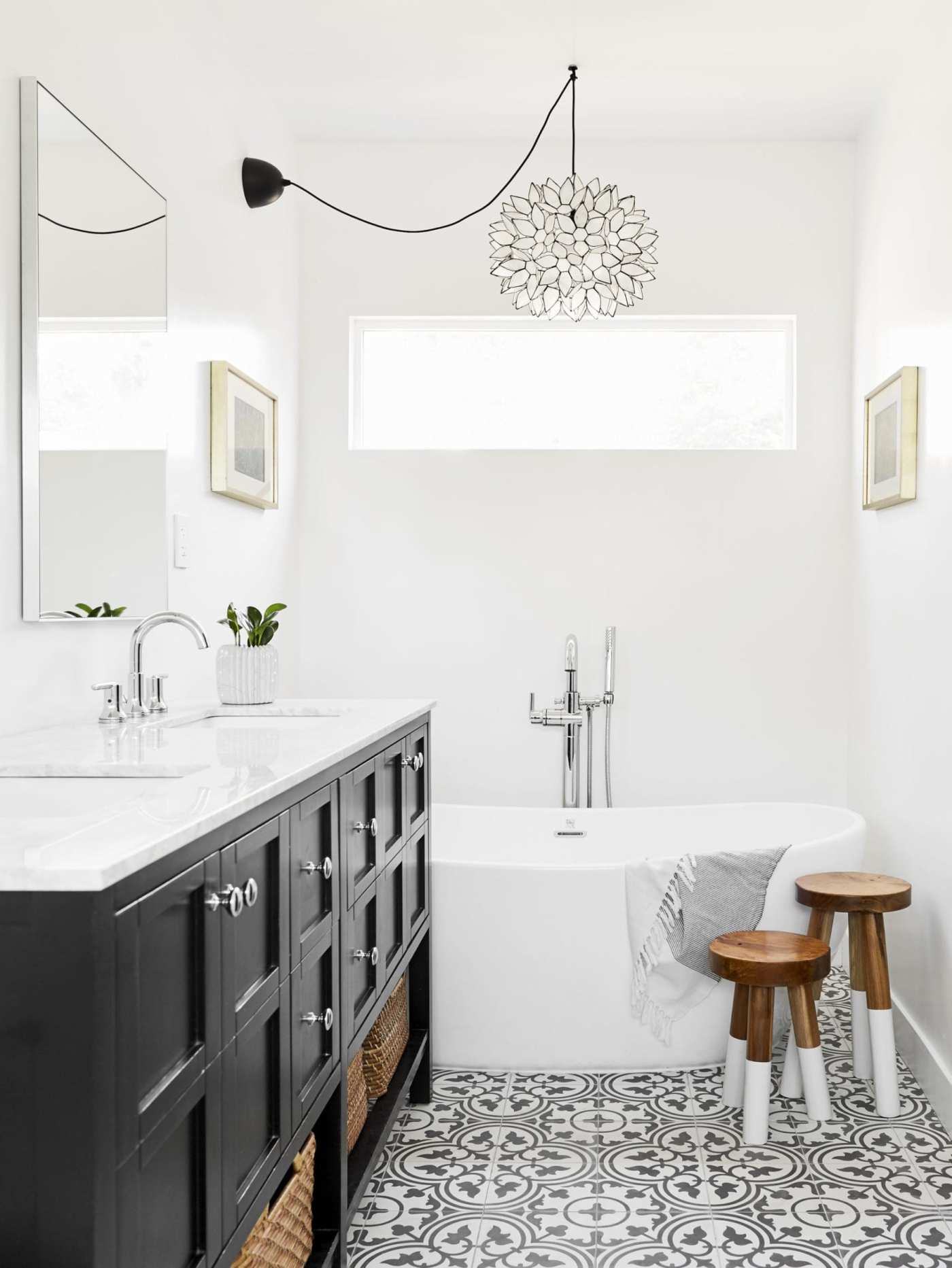 a black and white bathroom with a tub and sink.