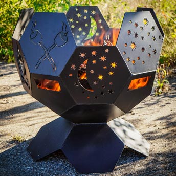 Photo of a large fire pit with stars and moon shape cut outs on a patio