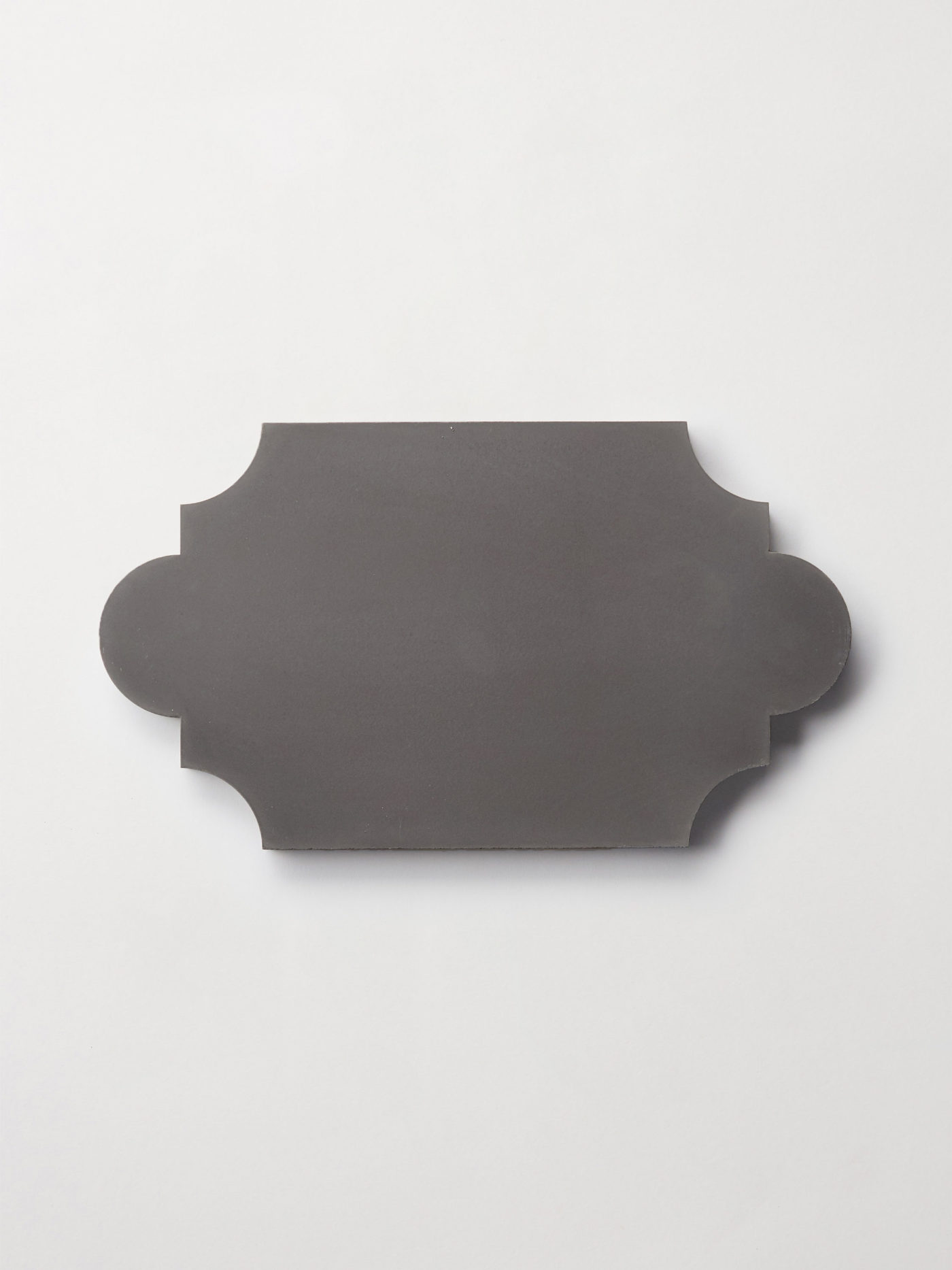 a black lantern-shaped tile on a white surface.