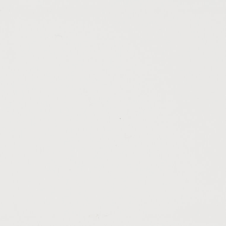 Plain white wall (no curtains or fixtures) bearing a faint diagonal shadow and tiny central speck, appearing unadorned in even, diffuse lighting with no visible furnishings.