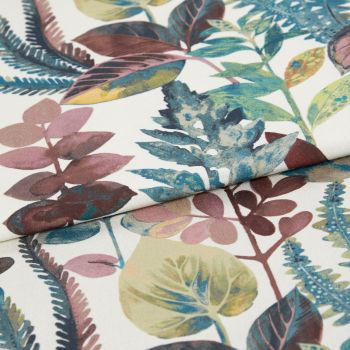 Botanical-print fabric with a white background and multicolored leaves (teal, olive, mauve), folded so an edge overlaps the center; close-up studio view with soft, even lighting.