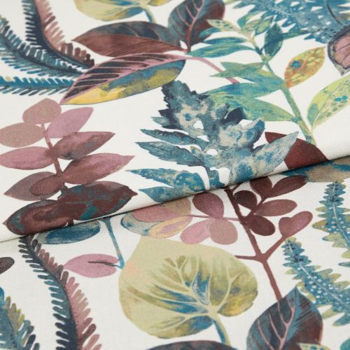Botanical-print fabric with a white background and multicolored leaves (teal, olive, mauve), folded so an edge overlaps the center; close-up studio view with soft, even lighting.