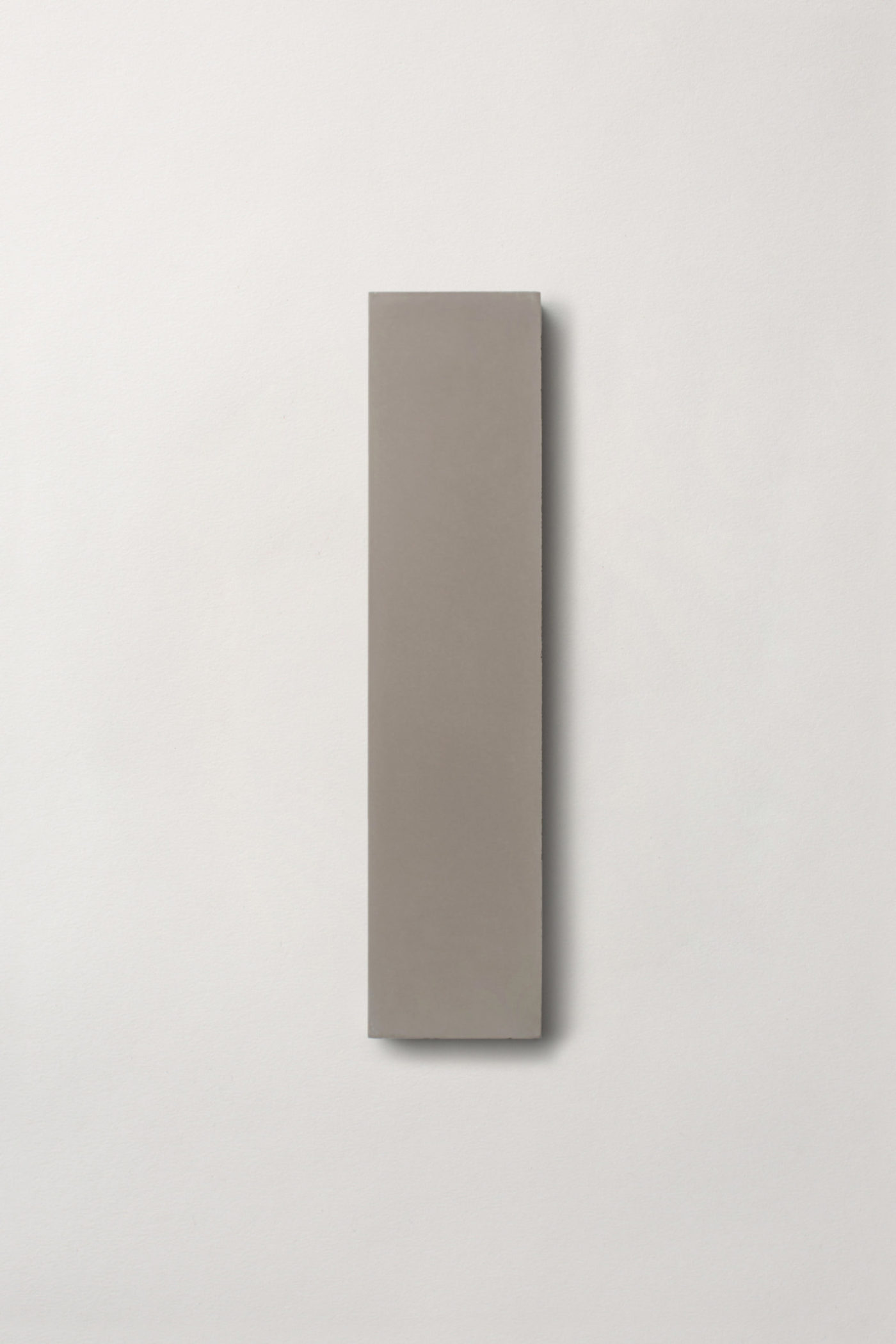 a grey rectangle tile on a white surface.