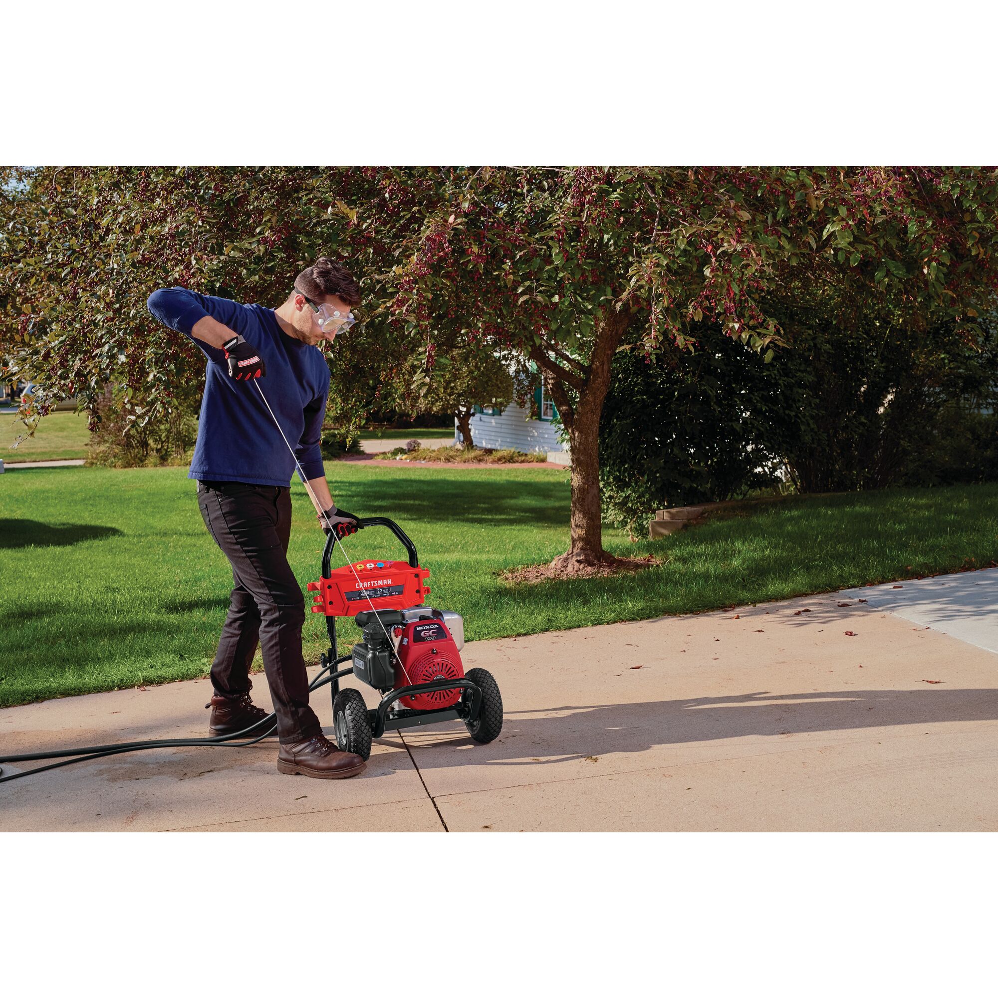 3300 Max P S I / 2.3 max G P M Pressure washer being used by a person to start washer.