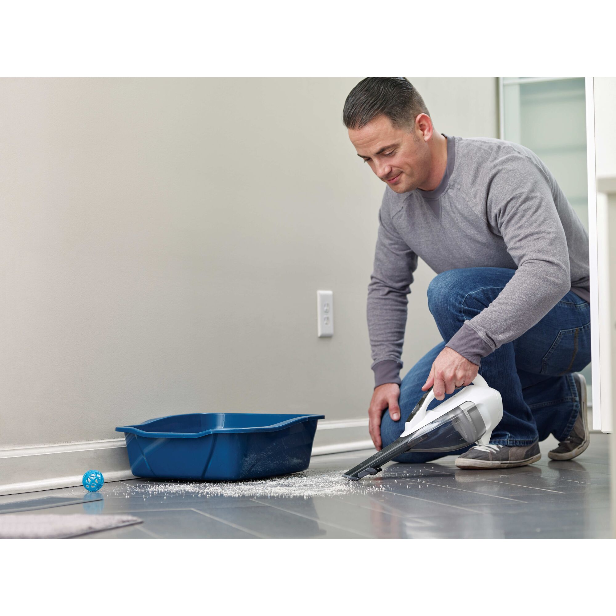dustbuster Advanced Clean cordless hand vacuum being used by a person to clean tiled floor.