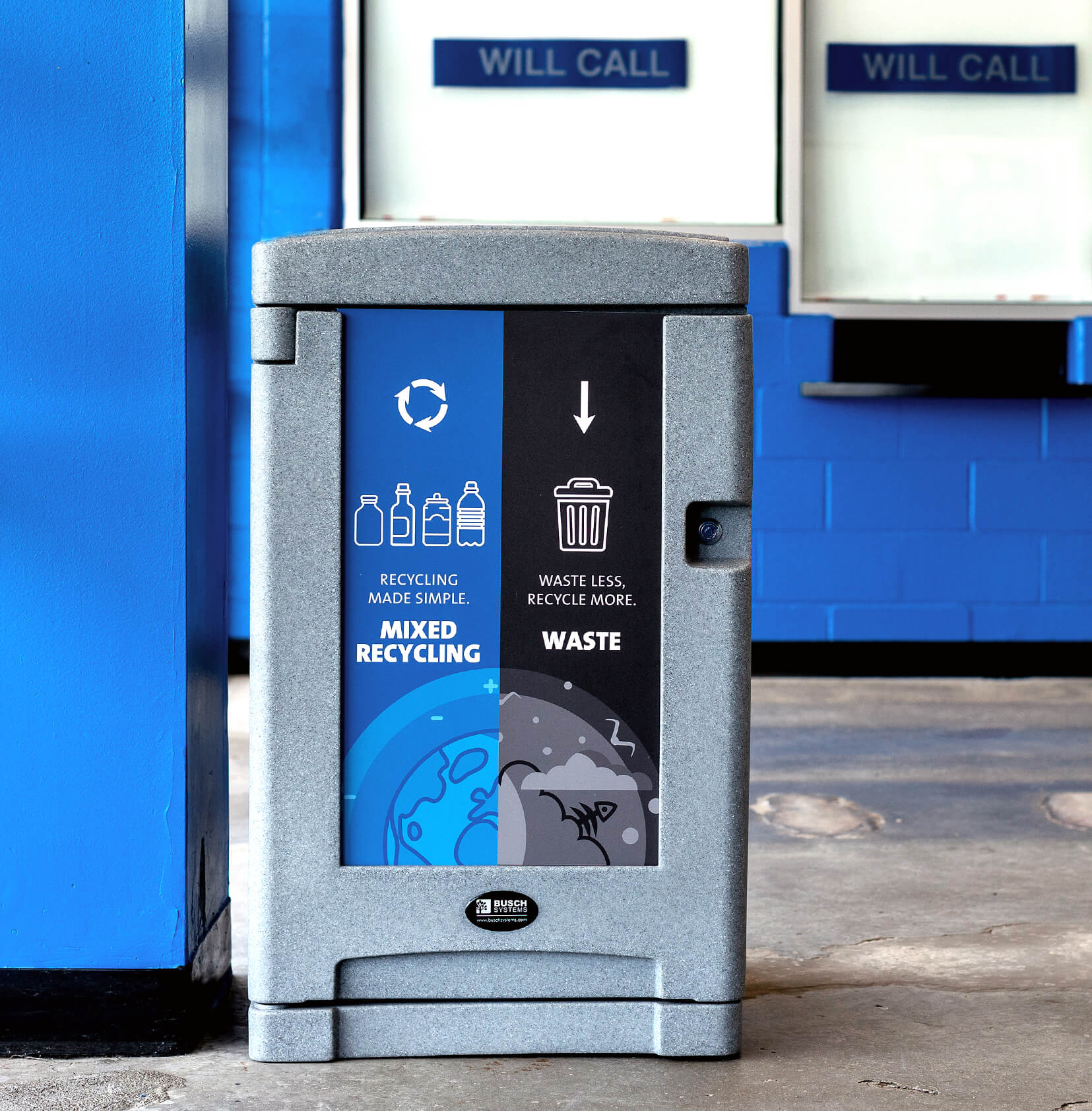 double grey plastic trash and recycling bin with large signs and door lock inside a hockey arena