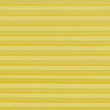 Yellow pleated cellular blind spanning the frame, horizontal accordion folds with textured fabric; fully lowered and closed, softly diffusing light in a neutral, evenly lit interior close-up with no visible view.