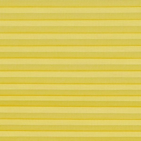 Yellow pleated cellular blind spanning the frame, horizontal accordion folds with textured fabric; fully lowered and closed, softly diffusing light in a neutral, evenly lit interior close-up with no visible view.