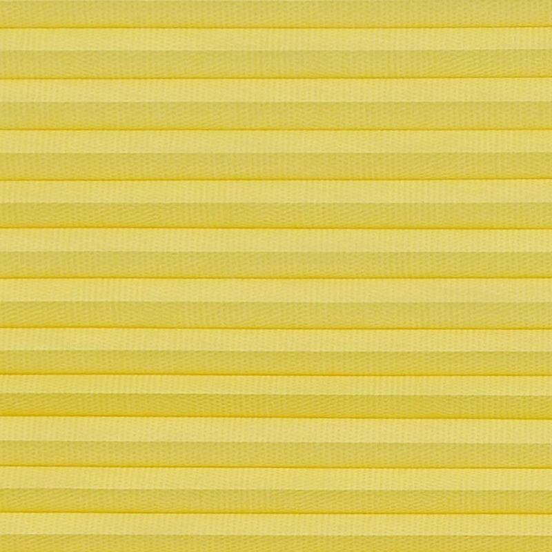 Yellow pleated cellular blind spanning the frame, horizontal accordion folds with textured fabric; fully lowered and closed, softly diffusing light in a neutral, evenly lit interior close-up with no visible view.