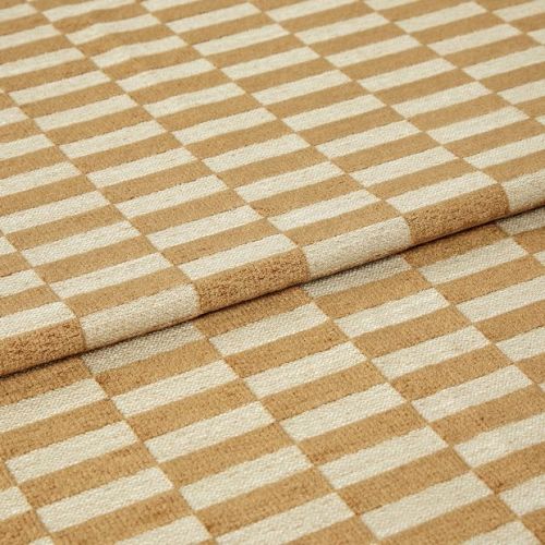 Woven beige-and-cream checkered fabric folded to create an overlapping edge, close-up studio-lit view highlighting the textured weave and repetitive rectangular pattern.