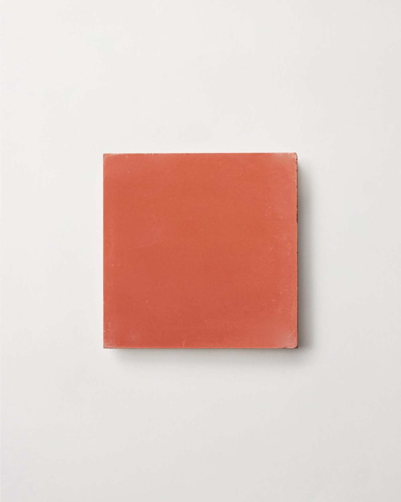 a square red tile on a white background.