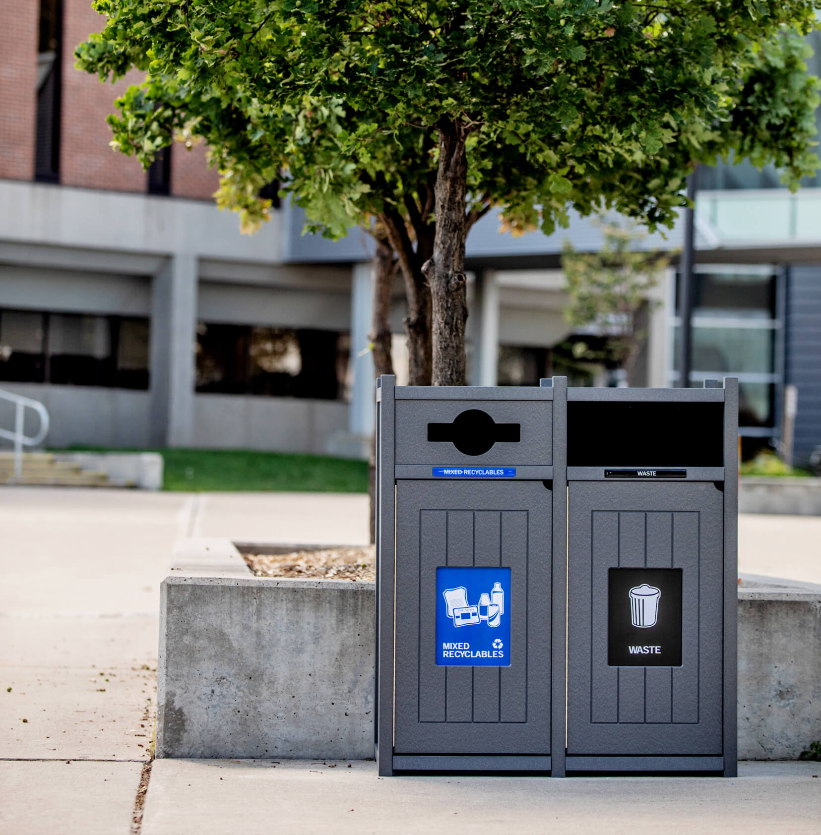 grey recycled plastic lumber recycling and waste container outdoors at a college campus