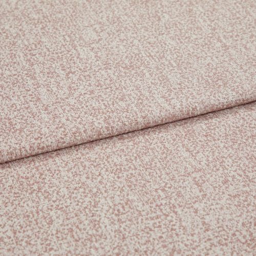 Pink-speckled upholstery fabric with a fine bouclé texture, folded and layered along a horizontal crease; lying flat in a close-up view with soft, even lighting.