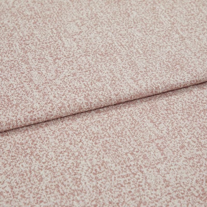 Pink-speckled upholstery fabric with a fine bouclÃ© texture, folded and layered along a horizontal crease; lying flat in a close-up view with soft, even lighting.